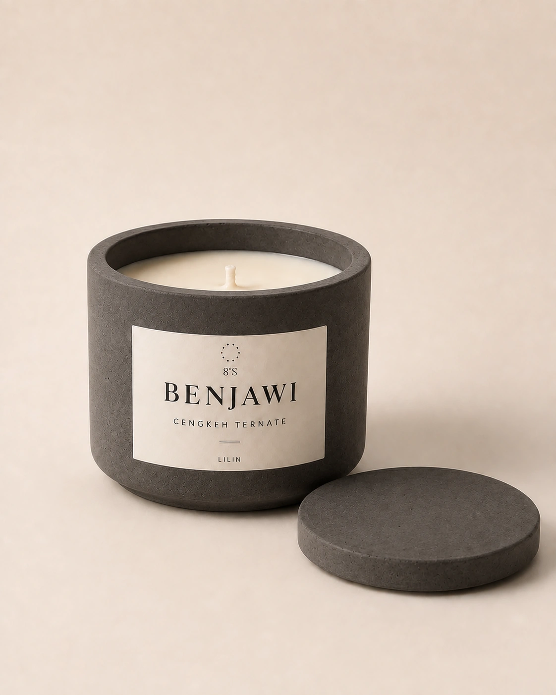Benjawi Cengkeh Ternate candle in a round charcoal concrete vessel, with ivory wax and a matching concrete lid beside it
