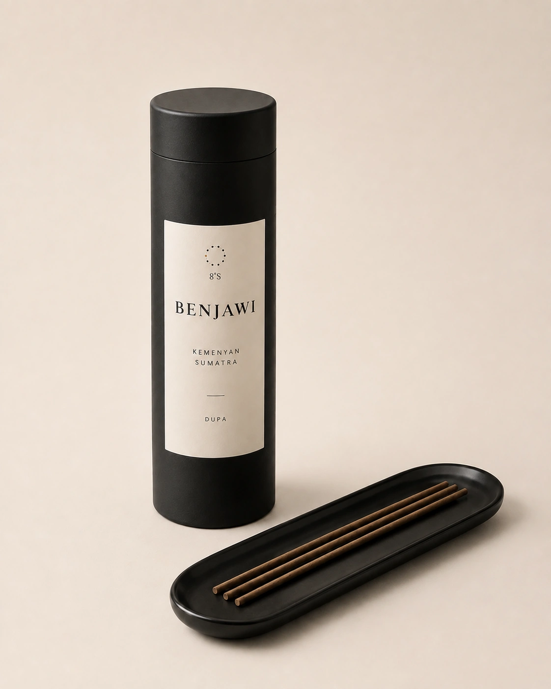 Benjawi Kemenyan Sumatra dupa in a round black canister beside three unlit incense sticks on a black tray