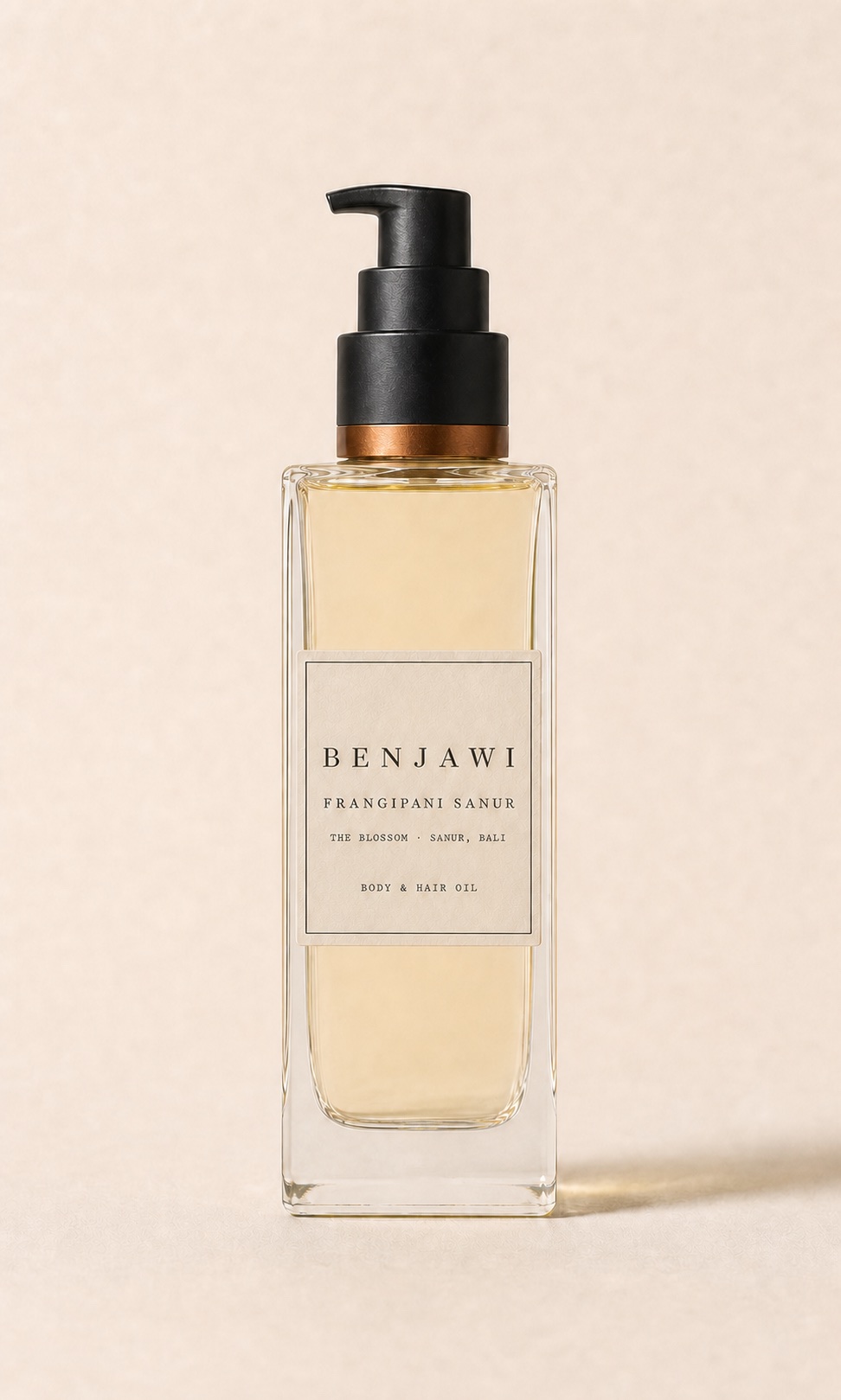 Benjawi Frangipani Sanur body and hair oil in a tall clear-glass pump bottle